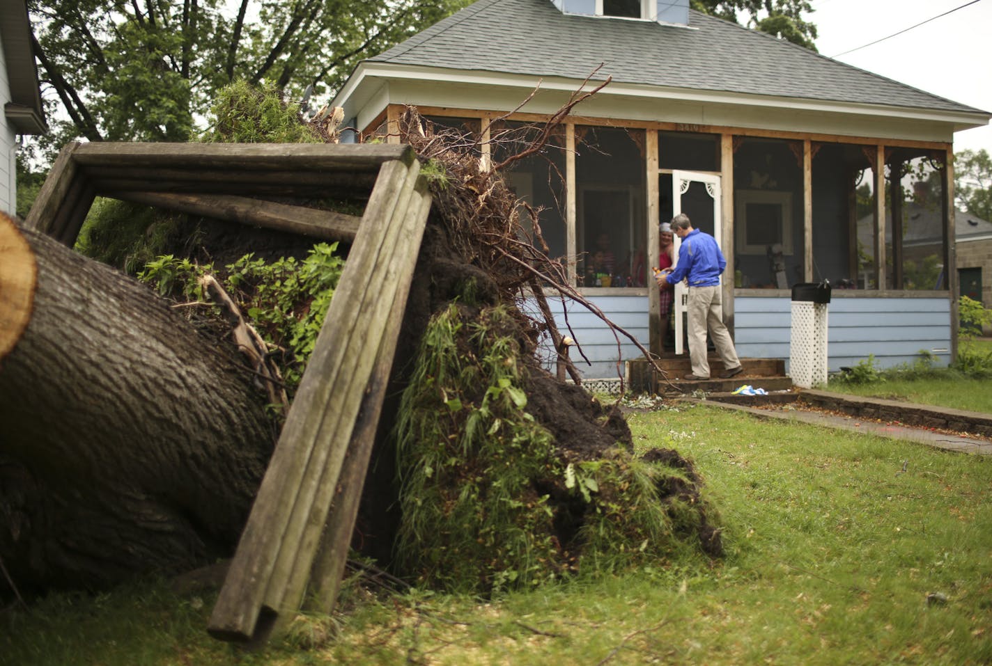 Minneapolis Mayor R.T. Rybak took to the streets of south Minneapolis Monday afternoon, June 24, 2013 to assess damage in some of the neighborhoods hit hardest by the recent storm. Minneapolis Mayor R.T. Rybak visited with Vaness Brom while she sat on her front porch Monday afternoon. There was a large tree in her front yard that came down in the storm on Friday and he was telling her that she could look at his Facebook page to find out more about what the city would be doing about removing fell