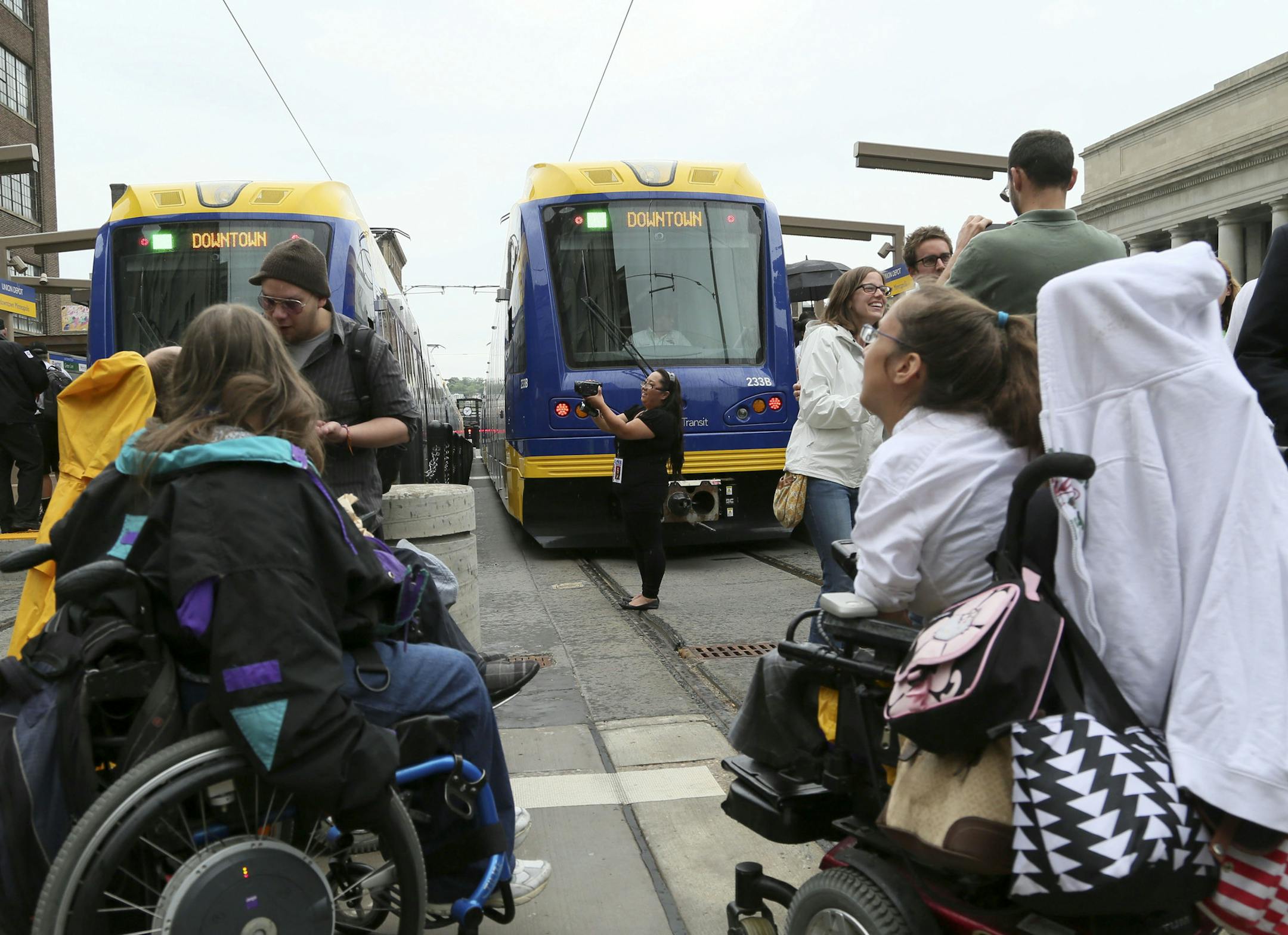 The first trains on the Greenline prepare to leave the station following an official ribbon cutting ceremony as Nancy Her of Hmong TV documents the scene Saturday, June 14, 2014, at Union Station in St. Paul, MN.] (DAVIDJOLES/STARTRIBUNE) djoles@startribune.com After more than a decade of planning and nearly a billion dollars of public money, the Twin Cities' second light-rail line begins running Saturday as officials cut ribbons for the Green Line.