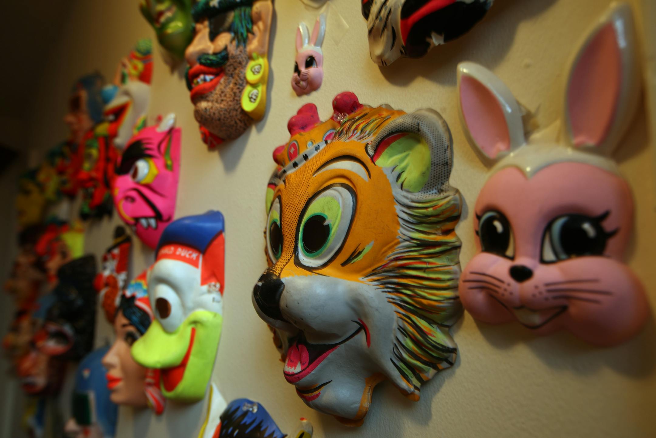 Halloween masks of on the wall of Charlotte Strait's Minneapolis apartment.