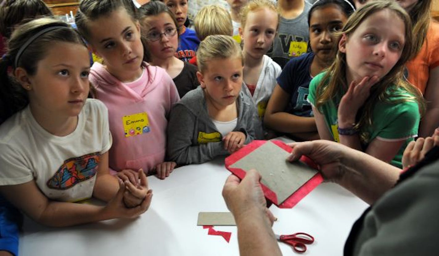 About 40 fourth graders from the St. Joseph's School in West St. Paul watched and listened to directions for making petal fold books in the Minnesota Center for Book Arts.