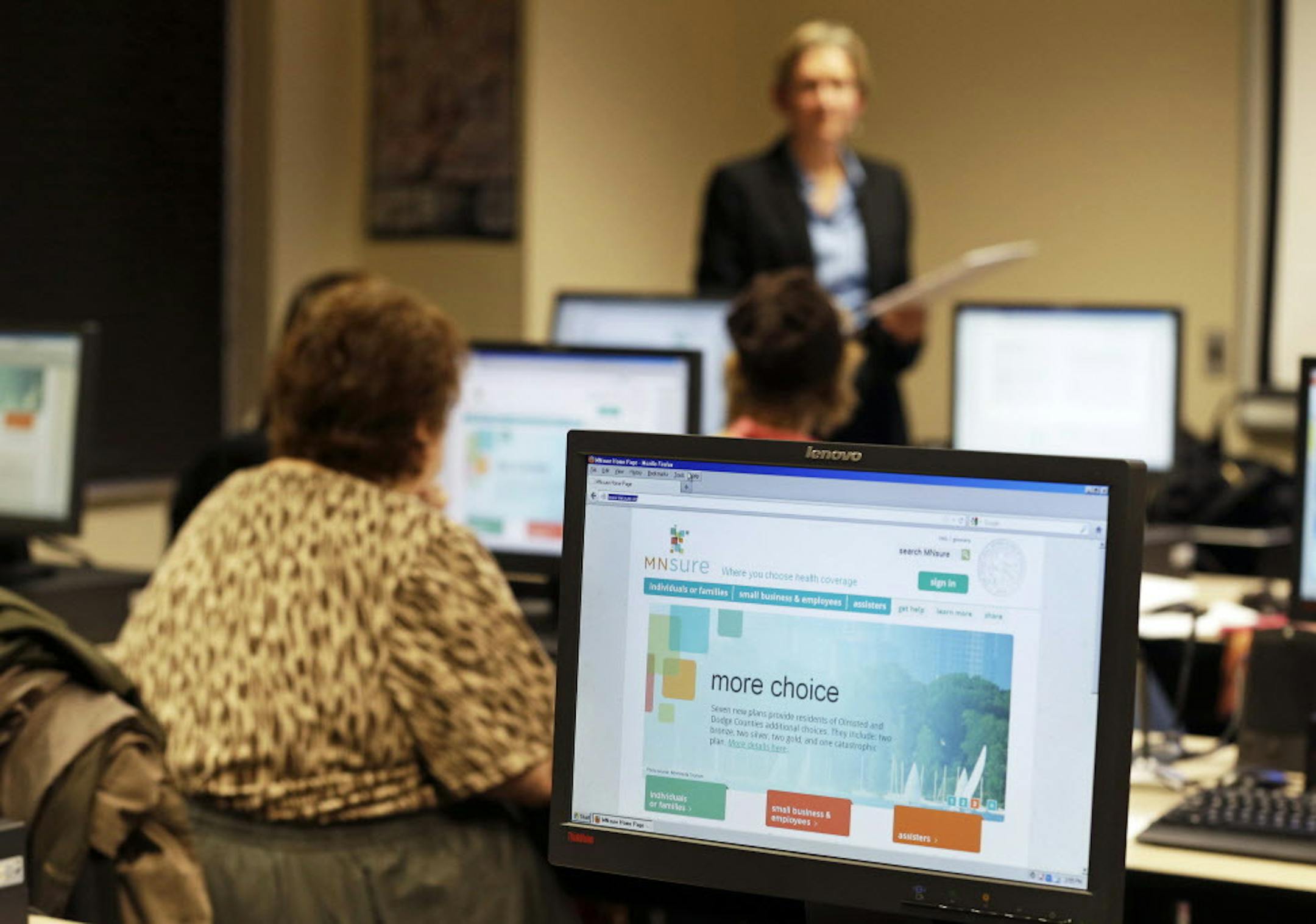 ADVANCE FOR MONDAY, NOV. 25 - In this photo made Wednesday, Nov. 13, 2013, Maureen O'Connell addresses people in attendance at the "MNsure Crash Course" at the St. Paul Library to help them understand how federal health care reform affects their lives. O'Connell is the co-founder and project manager for Health Access MN, a major beneficiary of $3.91 million from a federal government grant to private groups that pledge to recruit Minnesotans to sign up for coverage through the state's MNsure heal