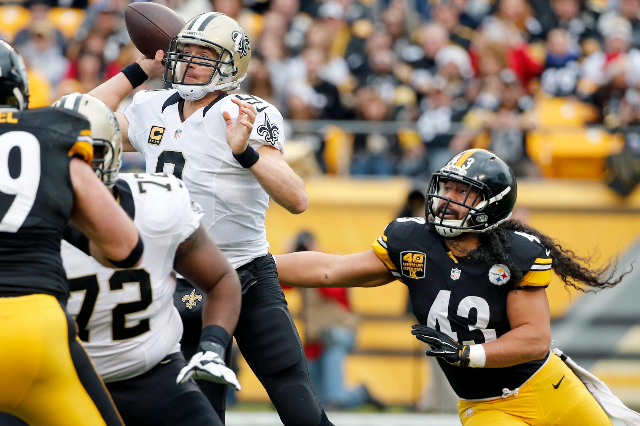 Pittsburgh Steelers strong safety Troy Polamalu (43) pressures New Orleans Saints quarterback Drew Brees (9) in the first quarter of the NFL football game, Sunday, Nov. 30, 2014 in Pittsburgh. (AP Photo/Gene J. Puskar)