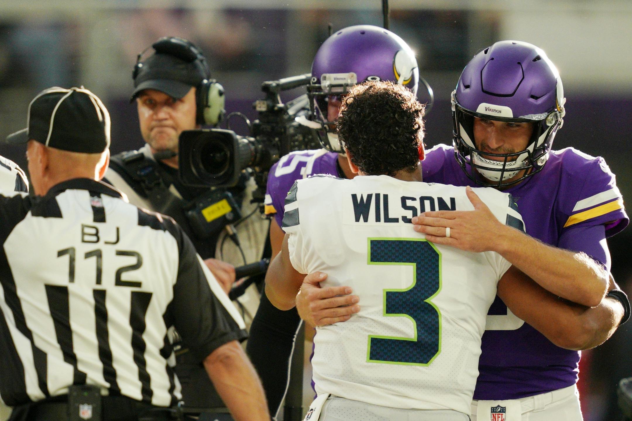 Minnesota Vikings quarterback Kirk Cousins (8) greeted Seattle Seahawks quarterback Russell Wilson (3) during the coin toss ahead of the first half.