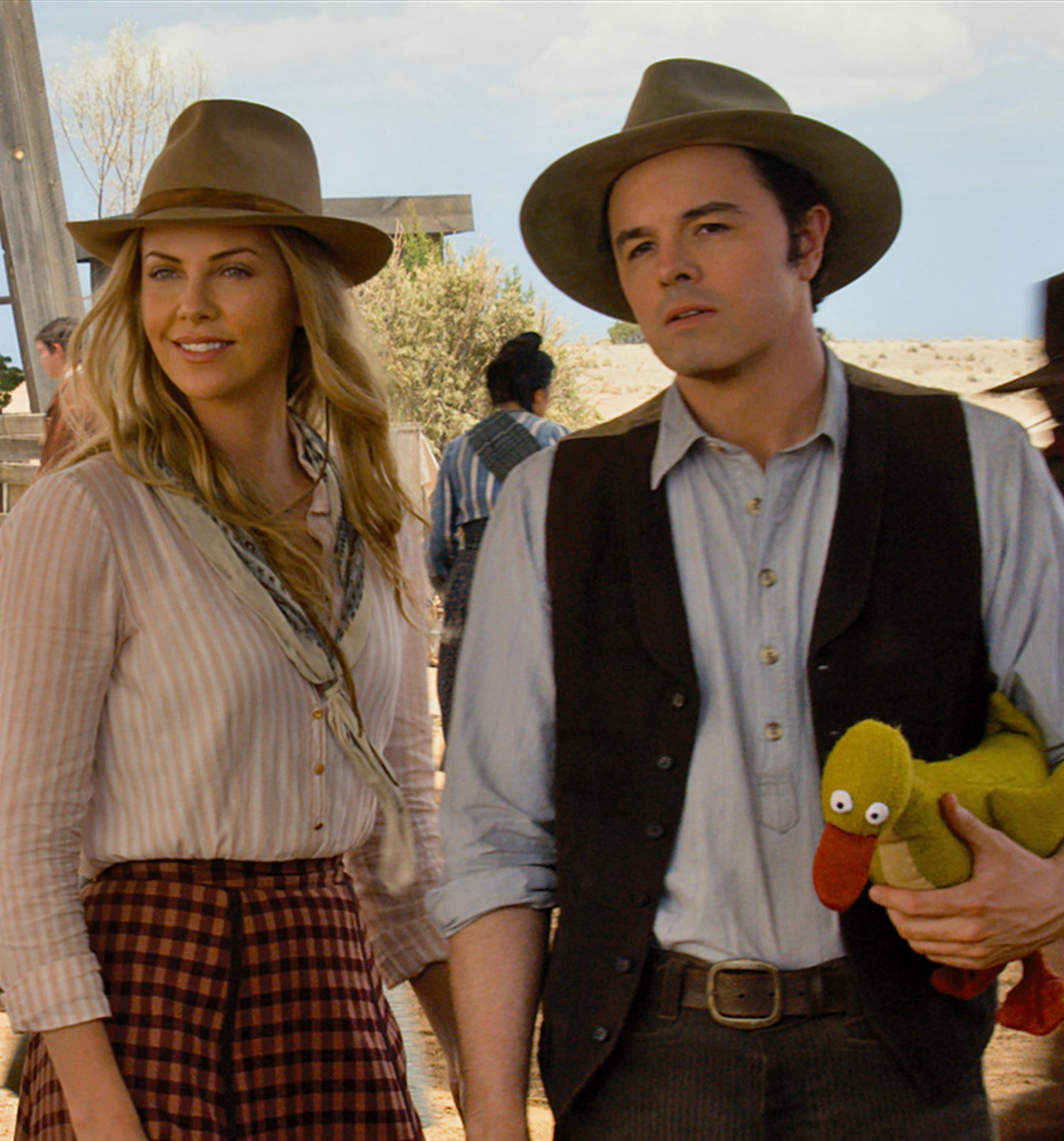 Anna (CHARLIZE THERON) and Albert (SETH MACFARLANE) try not to die at the fair in "A Million Ways to Die in the West", the new comedy from director, producer and co-writer MacFarlane, who plays a formerly cowardly sheep farmer who must put his newfound courage to the test. Photo Credit: Universal Pictures Copyright: &#xac;&#xa9; 2014 Universal Studios. ALL RIGHTS RESERVED.
