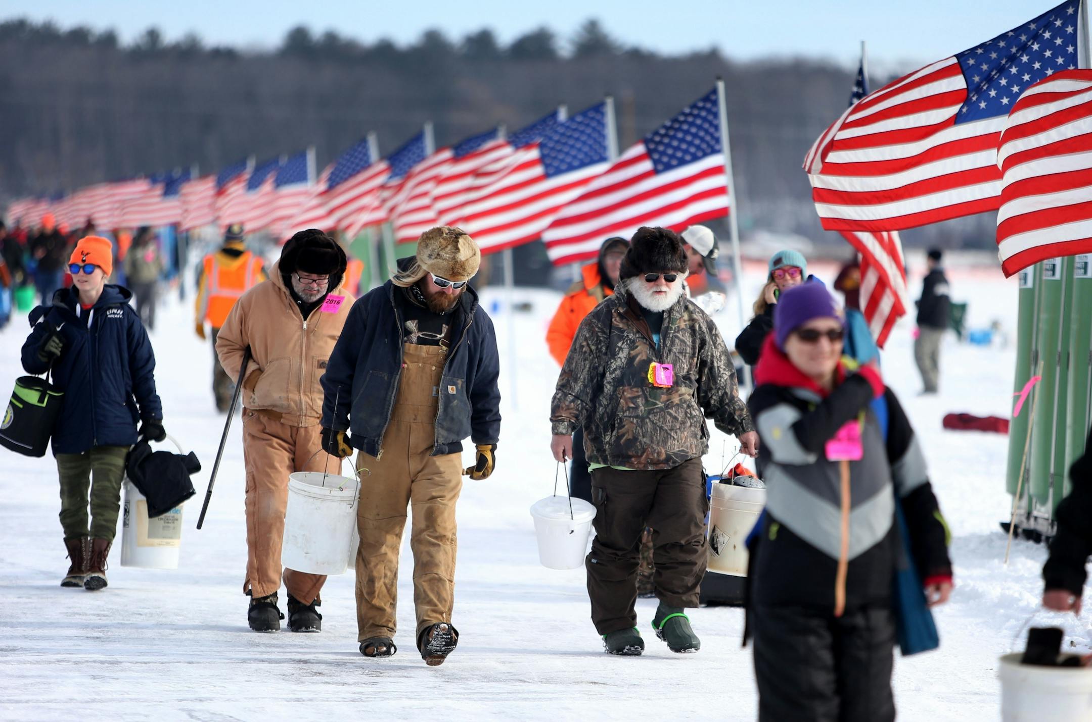 Gene Pivonka, second from right to left, and Casey Kirk, from Des Moines, IA, were among the 10,000 ice fishing contestants who headed to Hole in the Day Bay of Gull Lake for the Ice Fishing Extravaganza Saturday, Feb. 6, 2016, in Brainerd, MN.