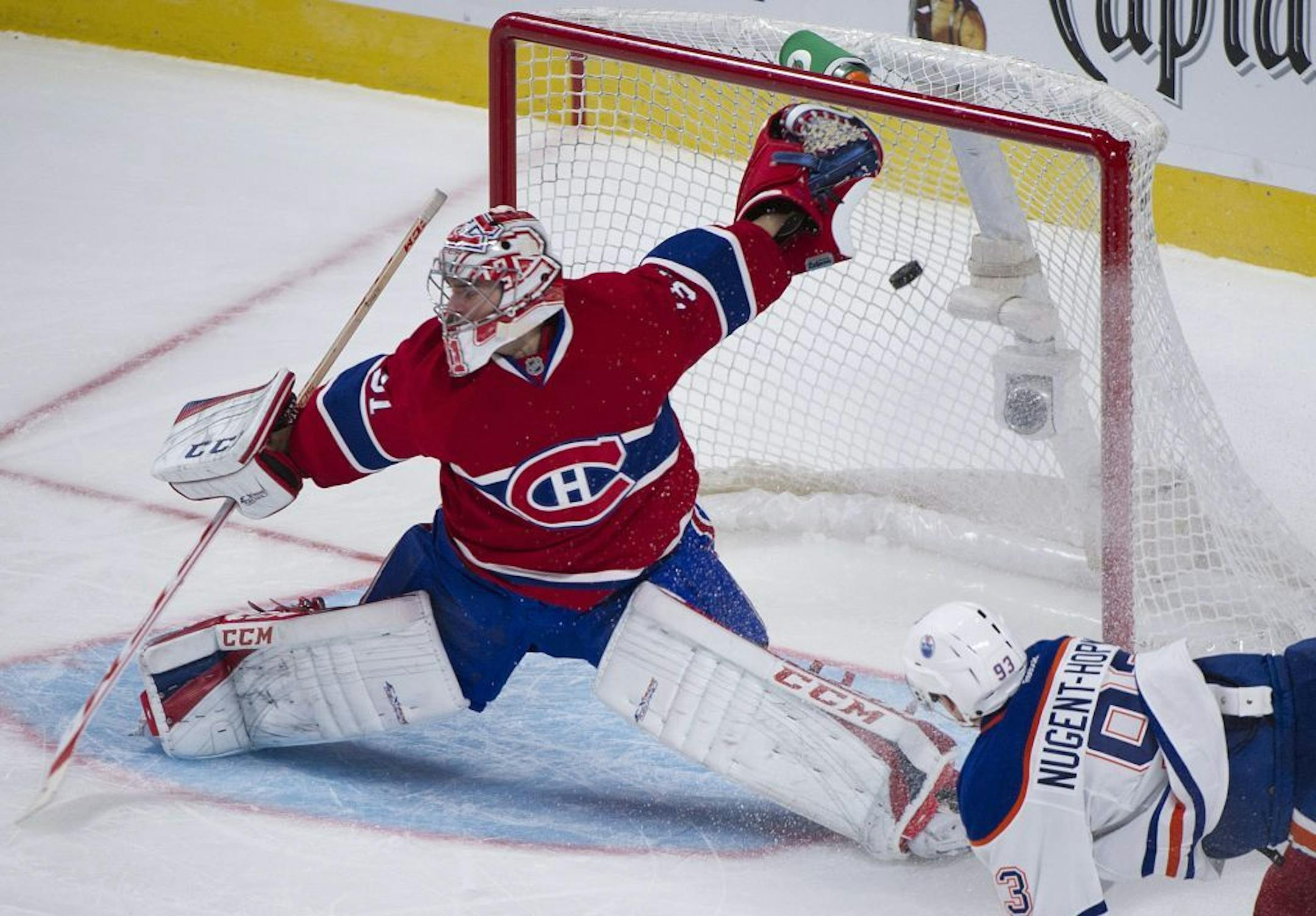 Montreal Canadiens' goaltender Carey Price is scored on by the Edmonton Oilers' Jeff Petry as Oilers' Ryan Nugent-Hopkins looks for the rebound during the third period of an NHL hockey game in Winnipeg, Manitoba, Tuesday, Oct. 22, 2013.
