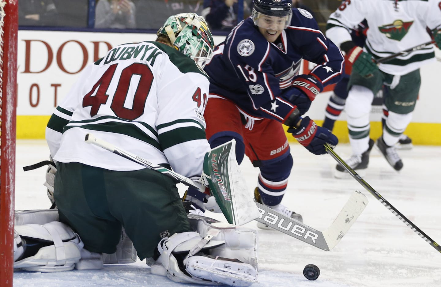 Minnesota Wild's Devan Dubnyk, left, makes a save against Columbus Blue Jackets' Cam Atkinson during the second period of an NHL hockey game Thursday, March 2, 2017, in Columbus, Ohio. (AP Photo/Jay LaPrete)