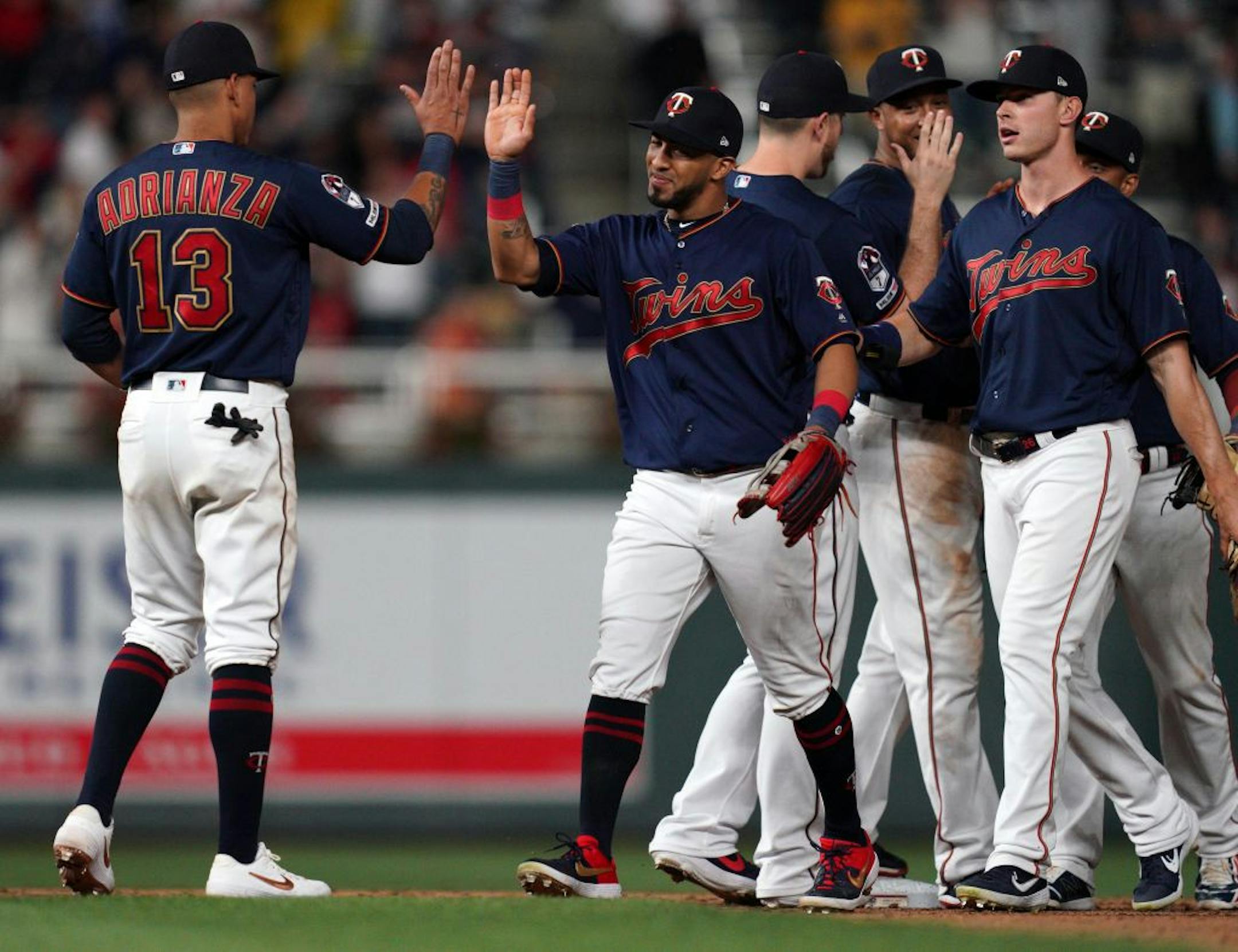 Minnesota Twins left fielder Eddie Rosario (20) celebrated the win with Minnesota Twins shortstop Ehire Adrianza (13).