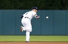 Detroit Tigers shortstop Jose Iglesias flips the ball to second base to start a double play against the Minnesota Twins in the first inning during a b