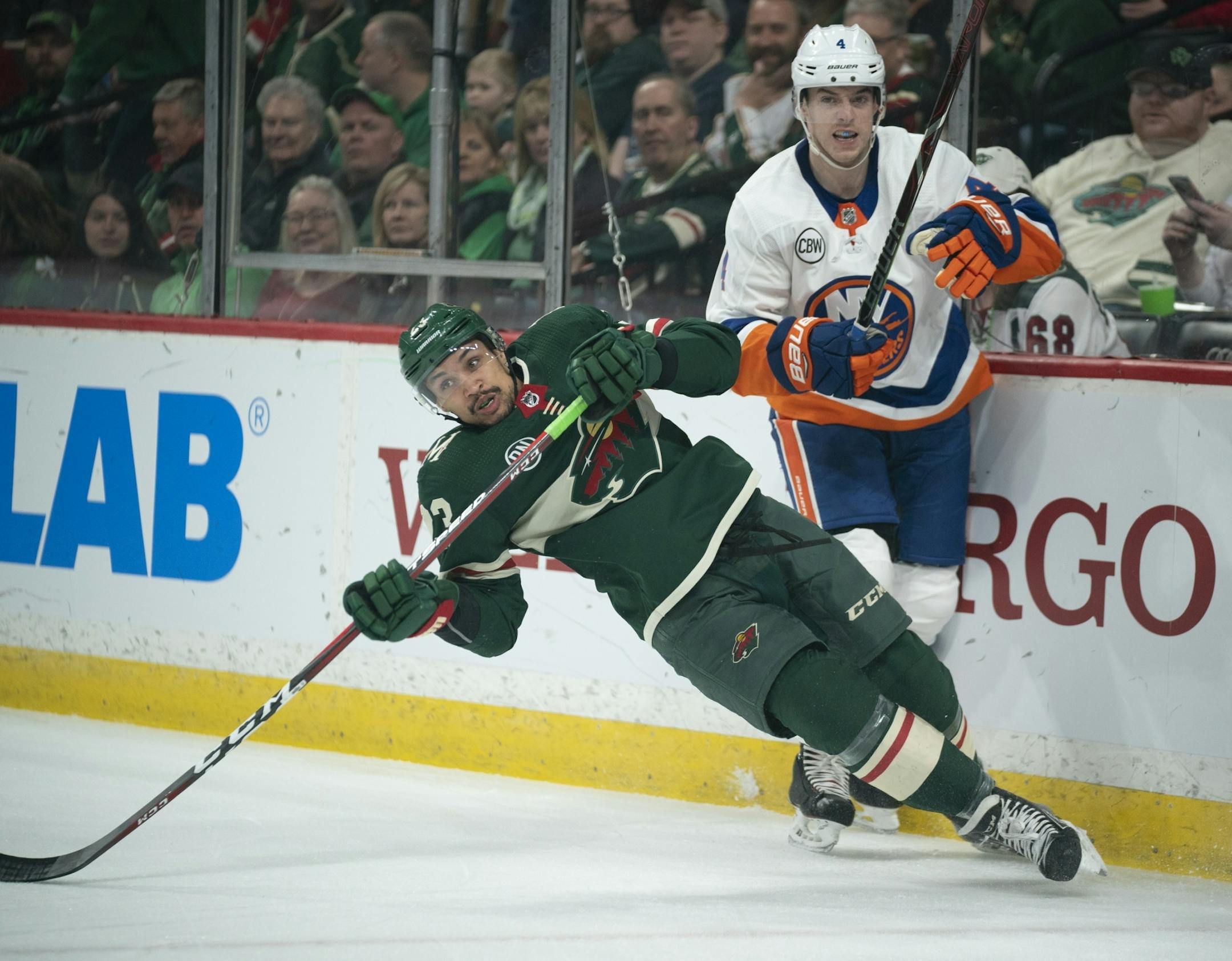 Minnesota Wild right wing J.T. Brown (23) lost his footing while working along the boards on New York Islanders defenseman Thomas Hickey (4) in the first period.