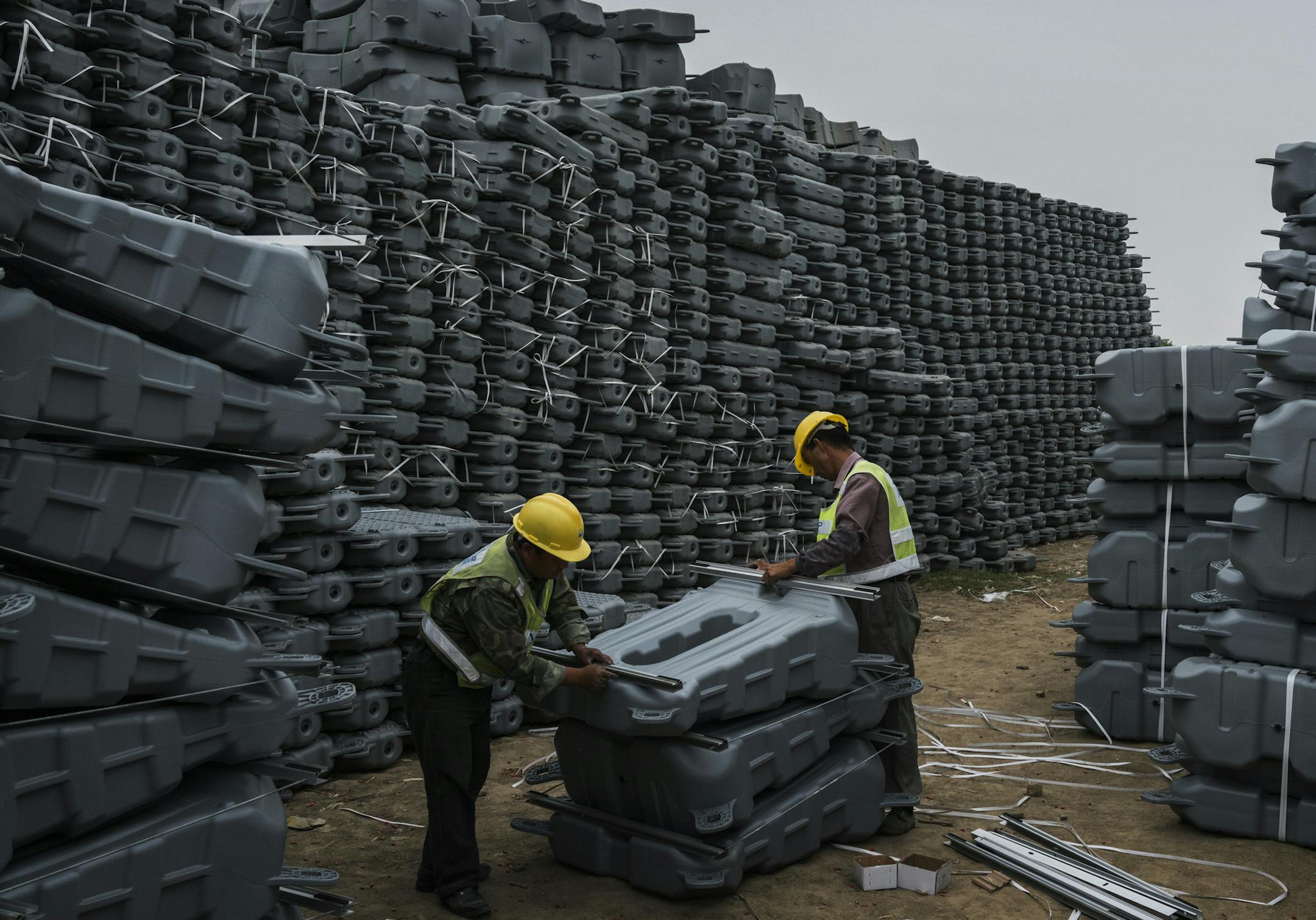 FILE -- Workers from Sungrow connect solar panels to custom made buoys on the banks of a lake in a flooded coal mine in Liulong Village, China, June 4, 2017. As the acrimony with the U.S. intensifies, Beijing’s immediate worry is how the Chinese public will handle the trade war and what impact it might have on domestic stability. (Adam Dean/The New York Times)