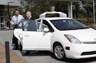 Senator Alex Padilla of California and California Gov. Jerry Brown arrive in a driverless car before a signing ceremony for SB 1298 at Google Headquar