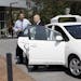 Senator Alex Padilla of California and California Gov. Jerry Brown arrive in a driverless car before a signing ceremony for SB 1298 at Google Headquar