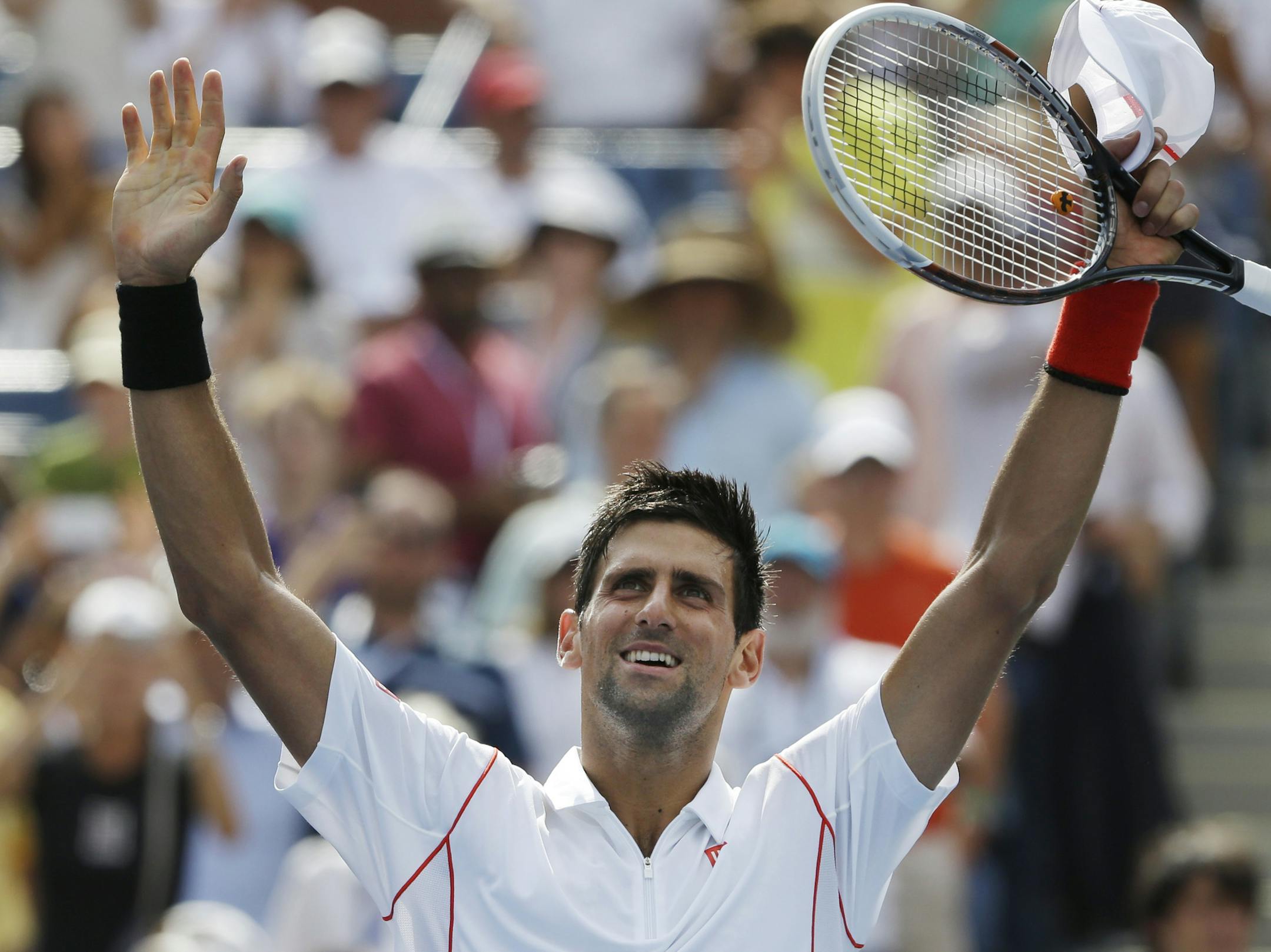 Novak Djokovic of Serbia waves to the crowd after beating Benjamin Becker of Germany during the second round of the 2013 U.S. Open tennis tournament, Friday, Aug. 30, 2013, in New York. (AP Photo/David Goldman)