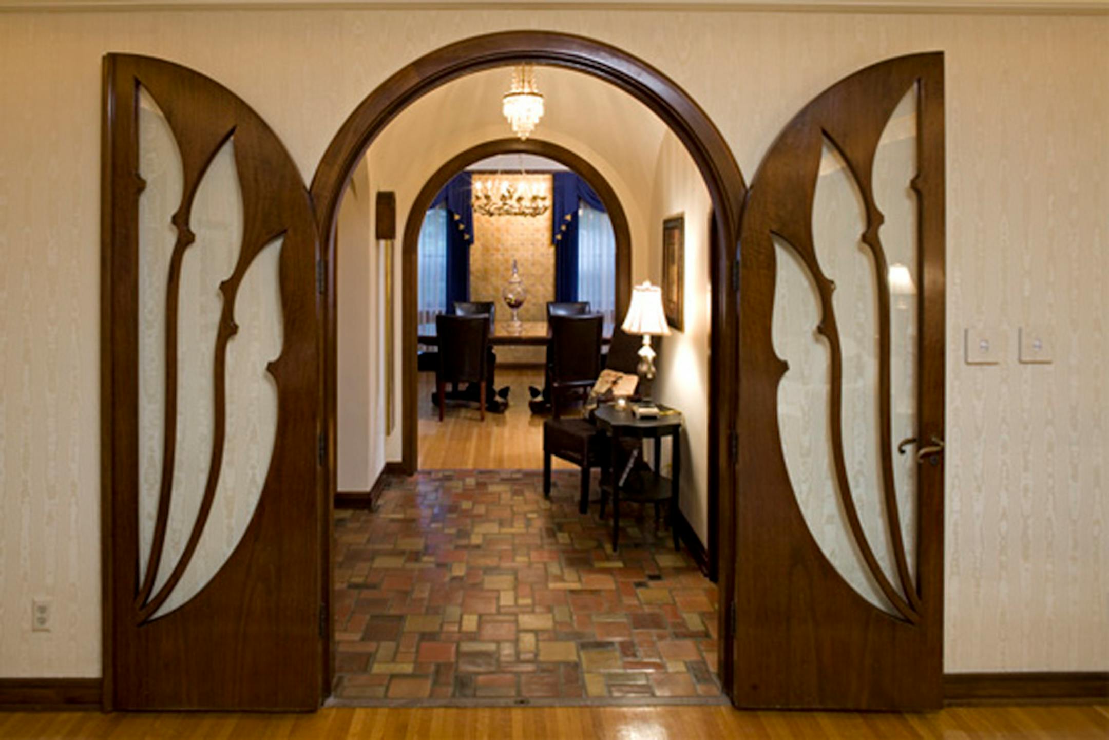 The Scandinavian-inspired tulip theme in this Spanish Revival house near Lake Nokomis shows up in a set of original entry doors of American black walnut that were hand-cut from the same tree and hand-rubbed with oil.