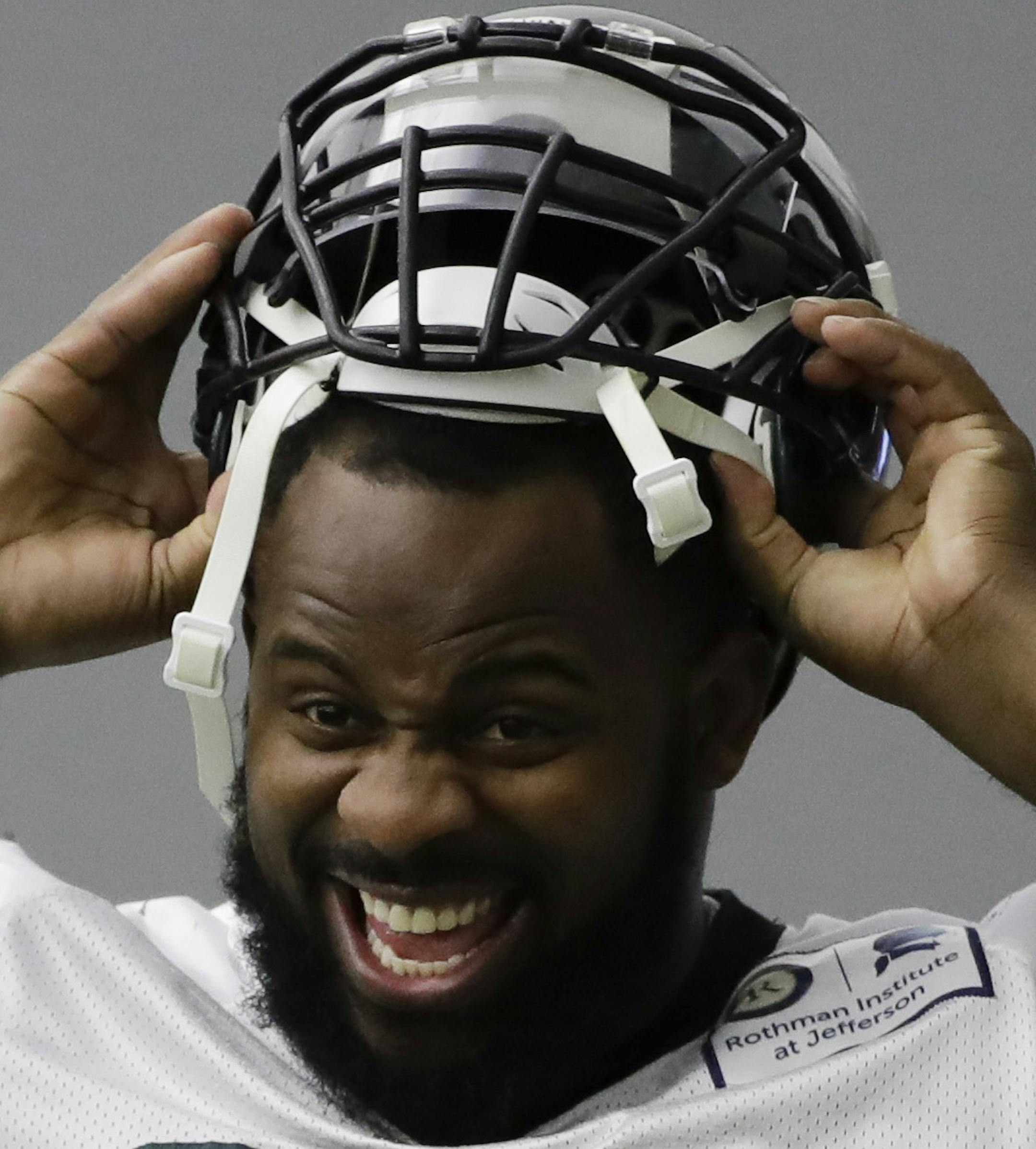 Philadelphia Eagles defensive tackle Fletcher Cox pulls on his helmet during practice at the team's NFL football training facility in Philadelphia, Thursday, Jan. 18, 2018. (AP Photo/Matt Rourke)