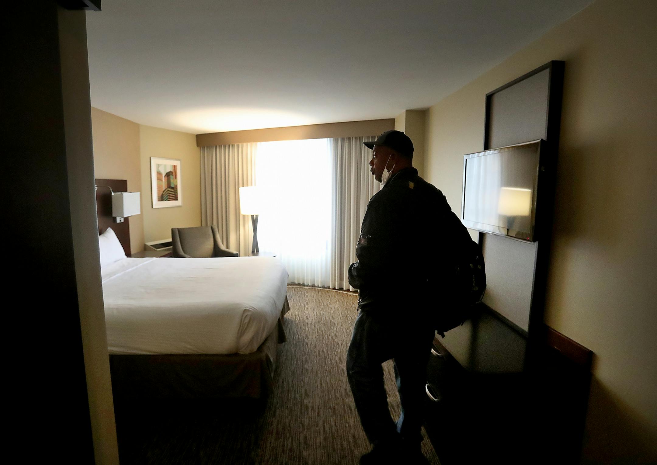After moving out of the Higher Ground homeless shelter in Minneapolis Douglas Pyle, 49, see his hotel room for the first time Friday, May 1, 2020, in Minneapolis, MN. Pyle is among more than 400 homeless people in Hennepin County who have been relocated to area hotels since the pandemic began. Pyle grew up in Indiana, spent a number of years in Florida and Madison, WI, before coming to Minneapolis 13 years ago and becoming homeless two years ago. Pyle said he hasn't slept in a bed for a long tim