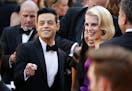 Rami Malek, left, and Lucy Boynton arrive at the Oscars on Sunday, Feb. 24, 2019, at the Dolby Theatre in Los Angeles.