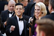 Rami Malek, left, and Lucy Boynton arrive at the Oscars on Sunday, Feb. 24, 2019, at the Dolby Theatre in Los Angeles.
