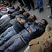 Indian men and women lie down on the ground mimicking dead bodies as they mourn the death of a gang rape victim in New Delhi, India, Saturday, Dec. 29