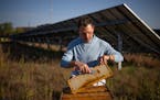 Dustin Vanasse, owner of Minneapolis-based Bare Honey, showed the honey made by the bees he keeps at the Connexus Energy solar array in Ramsey in Octo