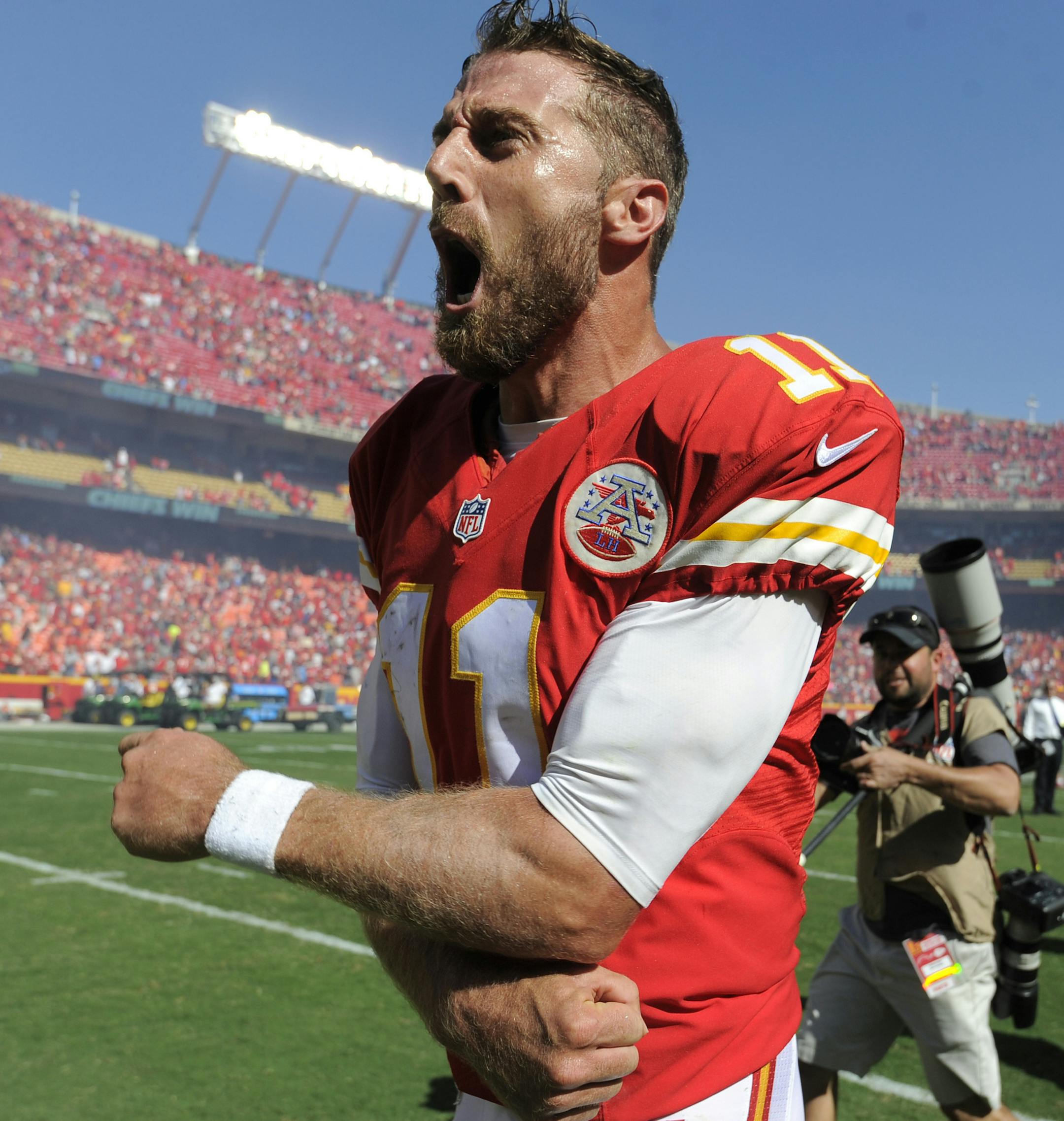 Kansas City Chiefs quarterback Alex Smith (11) celebrates after he scored the winning touchdown against the San Diego Chargers in overtime in an NFL football game in Kansas City, Mo., Sunday, Sept. 11, 2016. The Kansas City Chiefs won 33-27. (AP Photo/Ed Zurga)