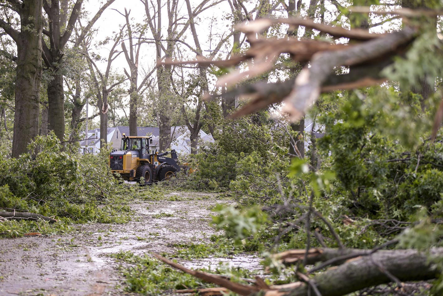 A loader clears a path from downed trees on Chandler Street SW, Monday, Aug. 10, 2020, in Cedar Rapids, Iowa. (Andy Abeyta/The Gazette via AP)