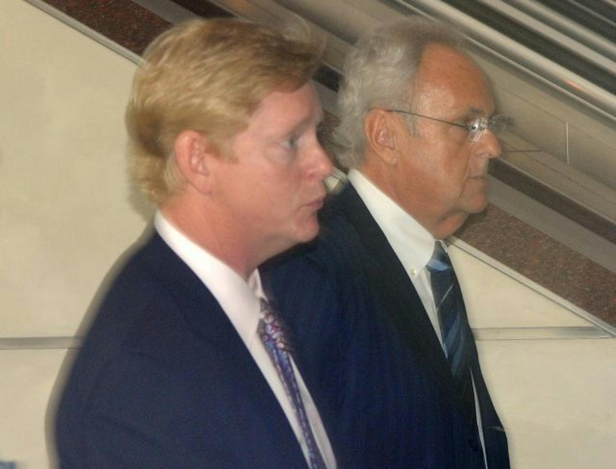 Denny Hecker, right, walked into bankruptcy court Wednesday with one of his lawyers. It was Hecker's first court appearance since filing for personal bankruptcy after the collapse of his automotive empire.