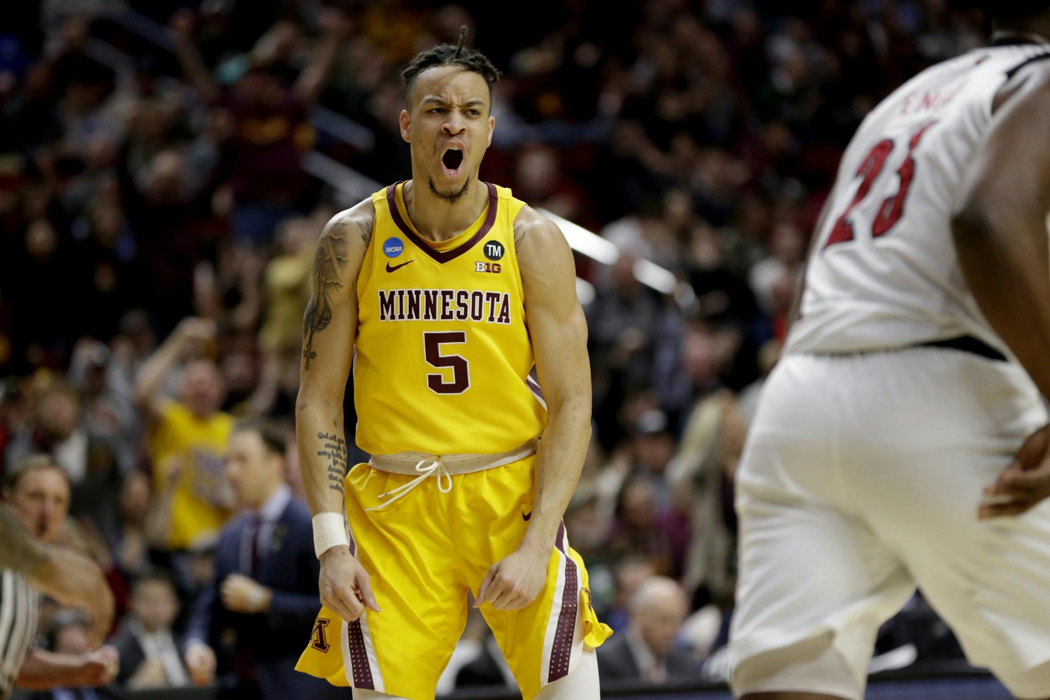 Minnesota's Amir Coffey (5) reacts after a basket against Louisville during the second half of a first round men's college basketball game in the NCAA Tournament, in Des Moines, Iowa, Thursday, March 21, 2019.