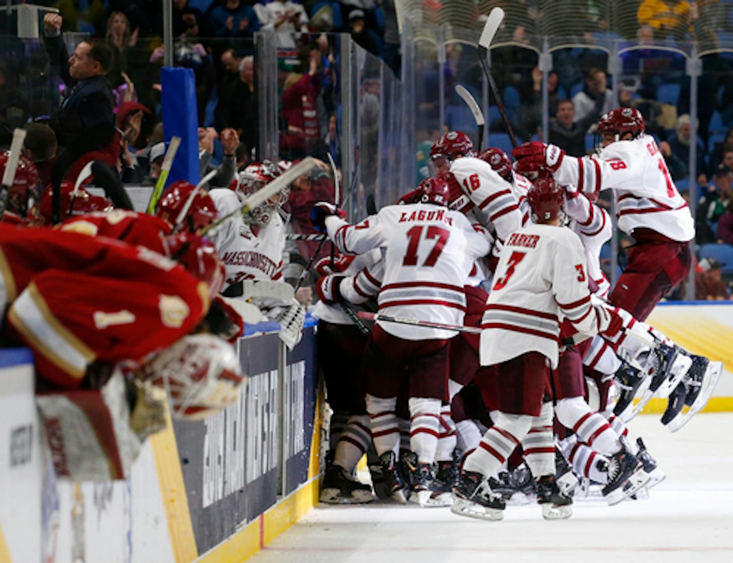 Massachusetts players celebrate a 4-3 overtime victory over Denver in the semifinals of the Frozen Four NCAA men's college hockey tournament Thursday, April 11, 2019, in Buffalo, N.Y. (AP Photo/Jeffrey T. Barnes)