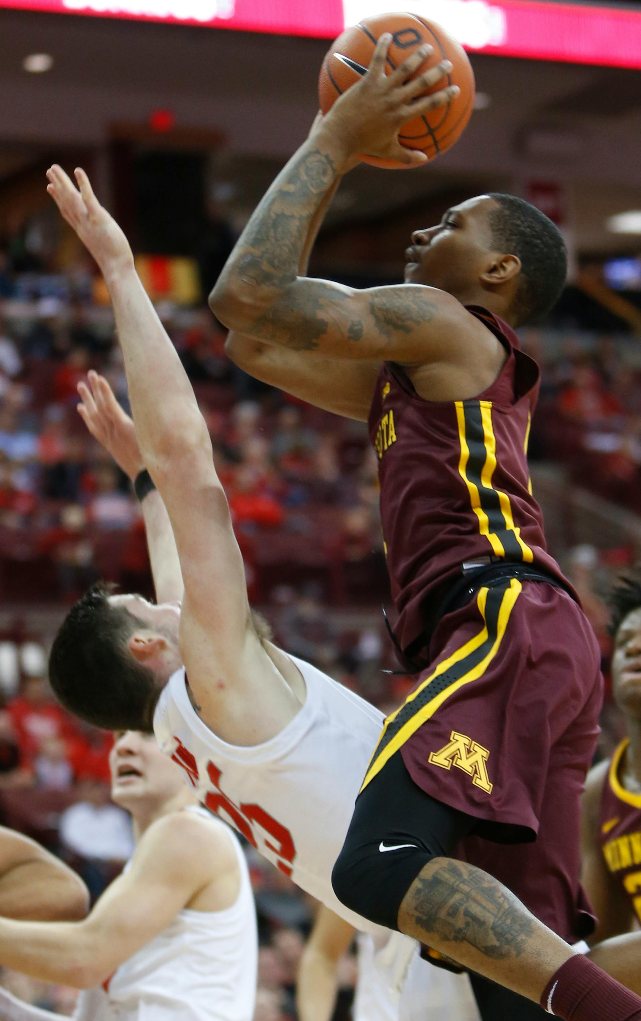 Minnesota's Dupree McBrayer, right, charges Ohio State's Kyle Young during the first half of an NCAA college basketball game Sunday, Dec. 2, 2018, in Columbus, Ohio. (AP Photo/Jay LaPrete)