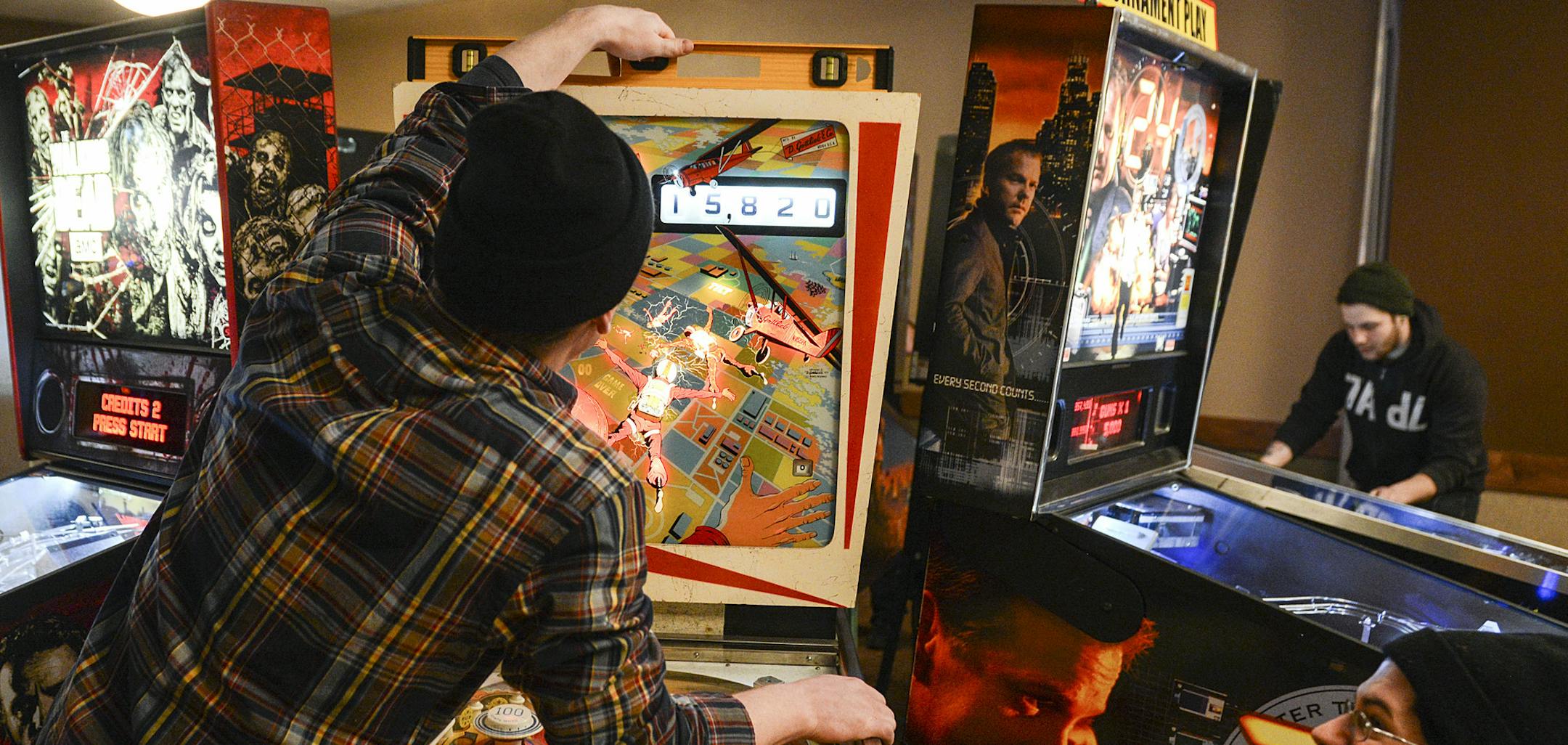 Derek Sanders checks to see if the machine is balanced after making a few adjustments. A couple of players got upset because he adjusted between players that were competing.] BRIDGET BENNETT • Special to the Star Tribune bridget.bennett@startribune.com IFPA Minnesota State Pinball Championship at Brunswick Zone XL in Brooklyn Park, MN on Feb. 7, 2015.