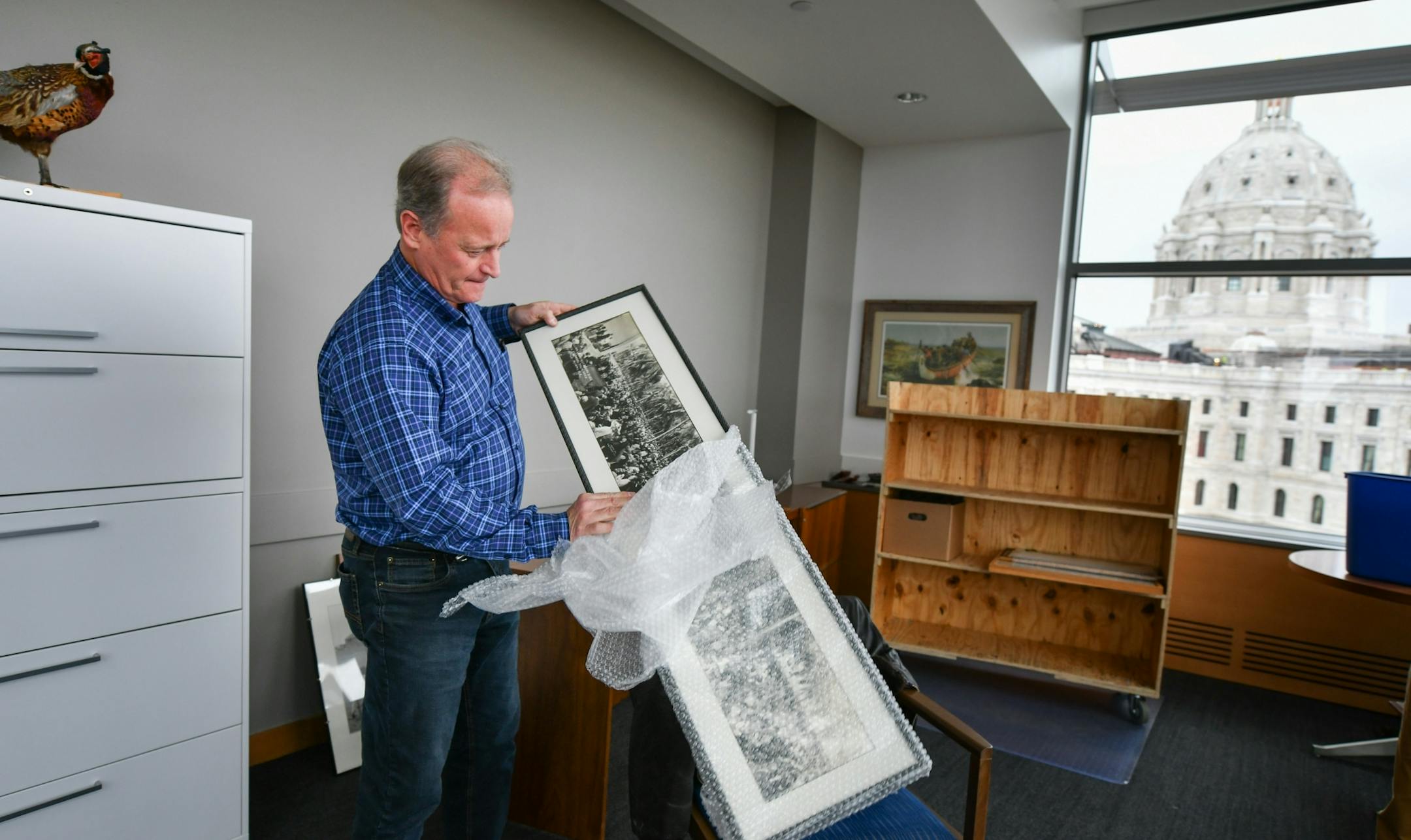 Republican Senator Warren Limmer unwrapped one of his favorite photos, of William Jennings Bryan speaking about the bible in Miami in the 1920's.