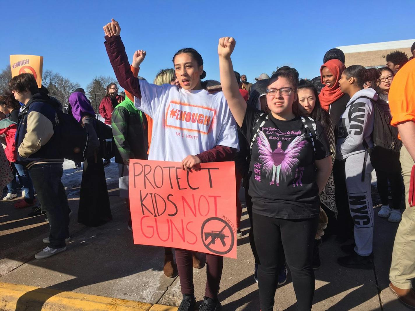 Students from Harding High School in St. Paul chant "end gun violence, we're tired of the silence."