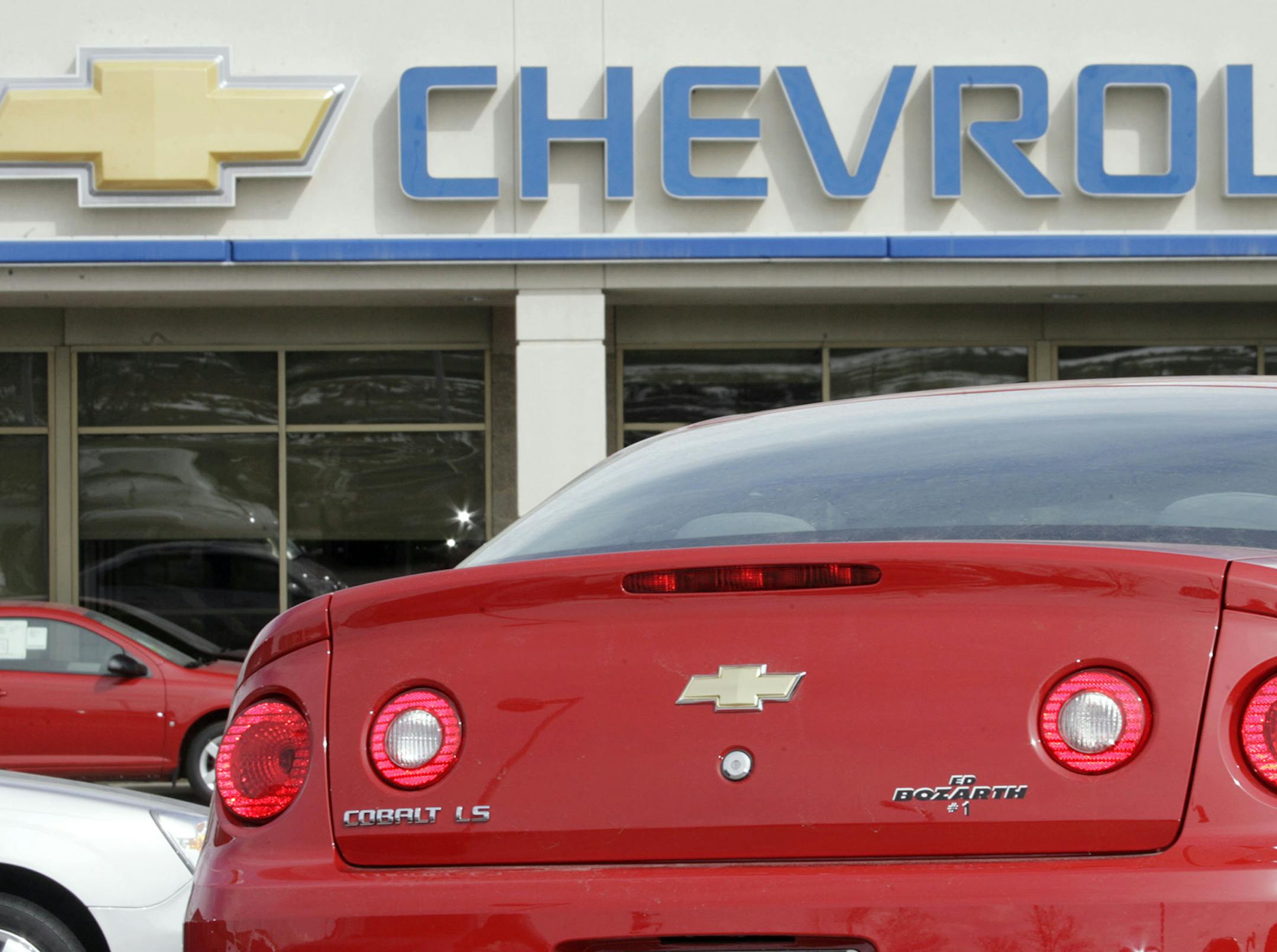 The company sign hangs over the tail of an unsold 2007 Cobalt coupe at a Chevrolet dealership in the southeast Denver suburb of Lone Tree, Colo., on Sunday, Feb. 25, 2007. General Motors Corp. said Thursday, March 1, 2007 its U.S. auto sales grew an unexpected 3.7 percent in February as stronger truck demand offset some weakness in its cars. (AP Photo/David Zalubowski) ORG XMIT: CODZ206