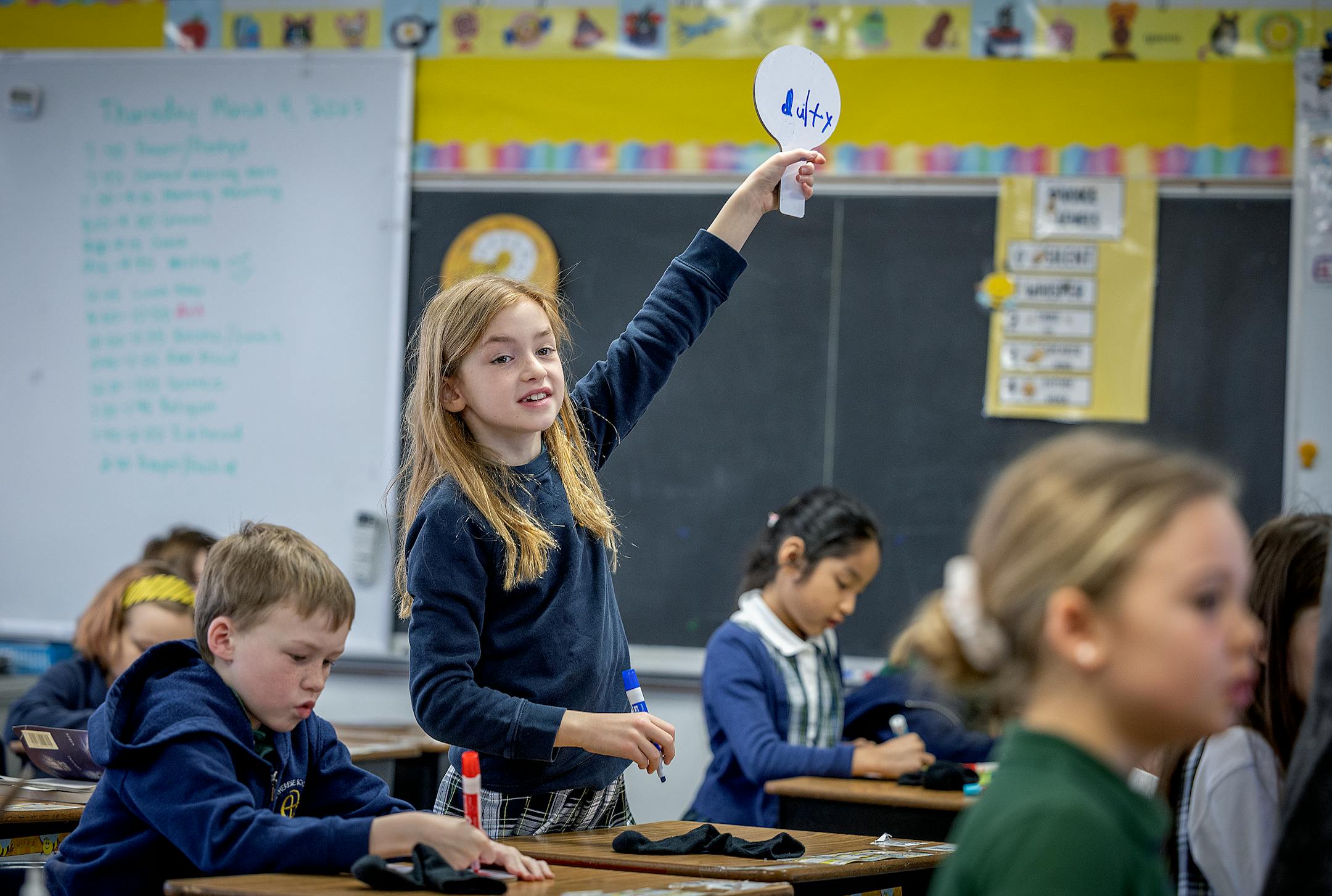 Cate Schneider works on spelling in Michelle Vidmar's second grade class at St. Therese Catholic School in Deephaven.