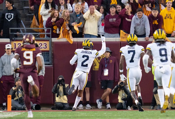 Michigan defensive back Will Johnson (2) celebrates after scoring off an interception on the second play of the game against Minnesota in the first qu