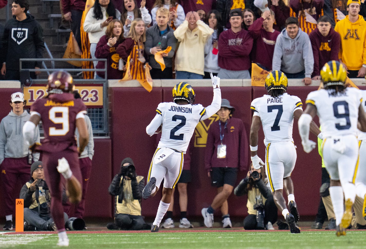 Michigan defensive back Will Johnson (2) celebrates after scoring off an interception on the second play of the game against Minnesota in the first quarter Saturday, Oct. 07, 2023, at Huntington Bank Stadium in Minneapolis, Minn. ]