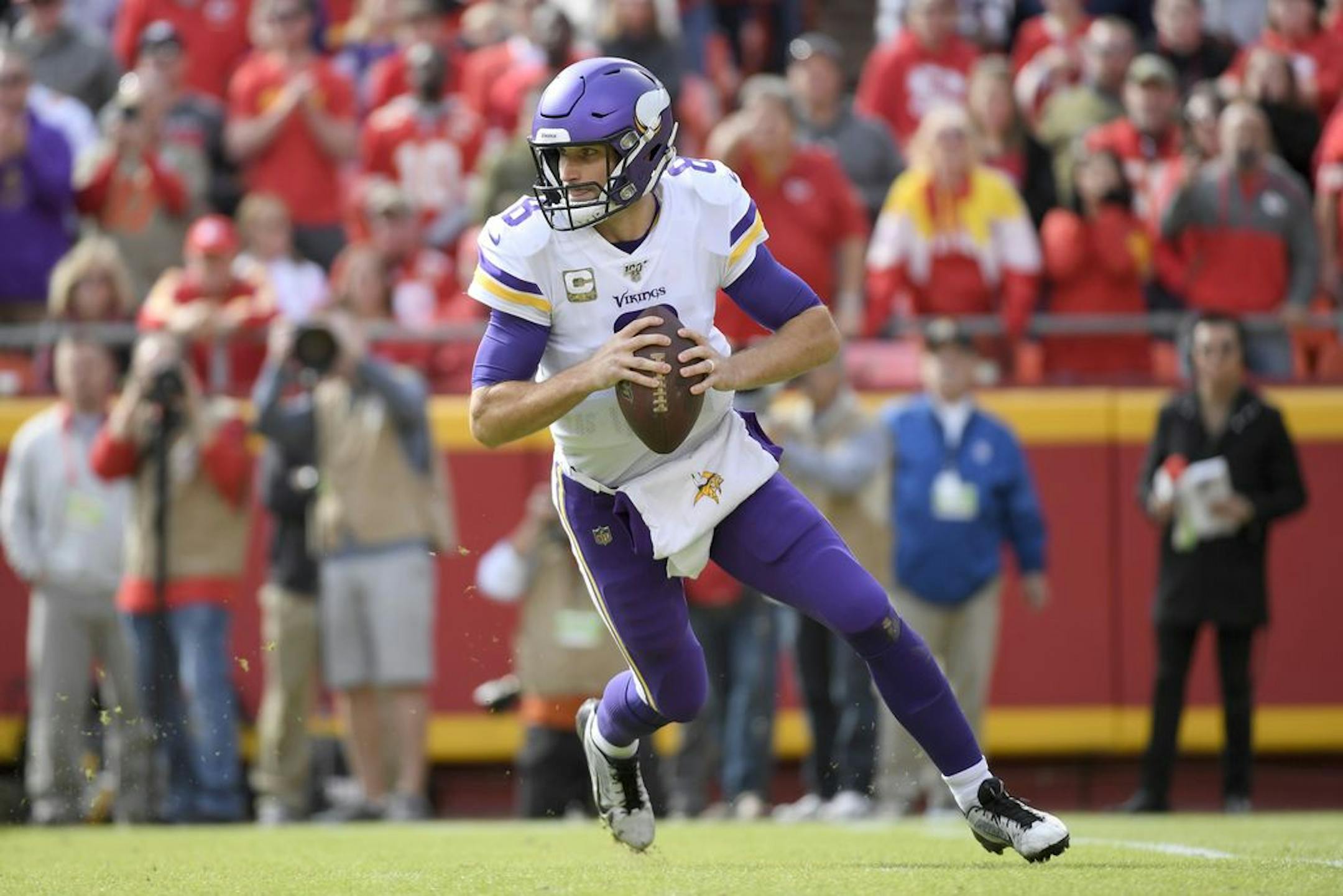 Minnesota Vikings quarterback Kirk Cousins (8) rolls out during the first half of an NFL football game against the Kansas City Chiefs in Kansas City, Mo., Sunday, Nov. 3, 2019.