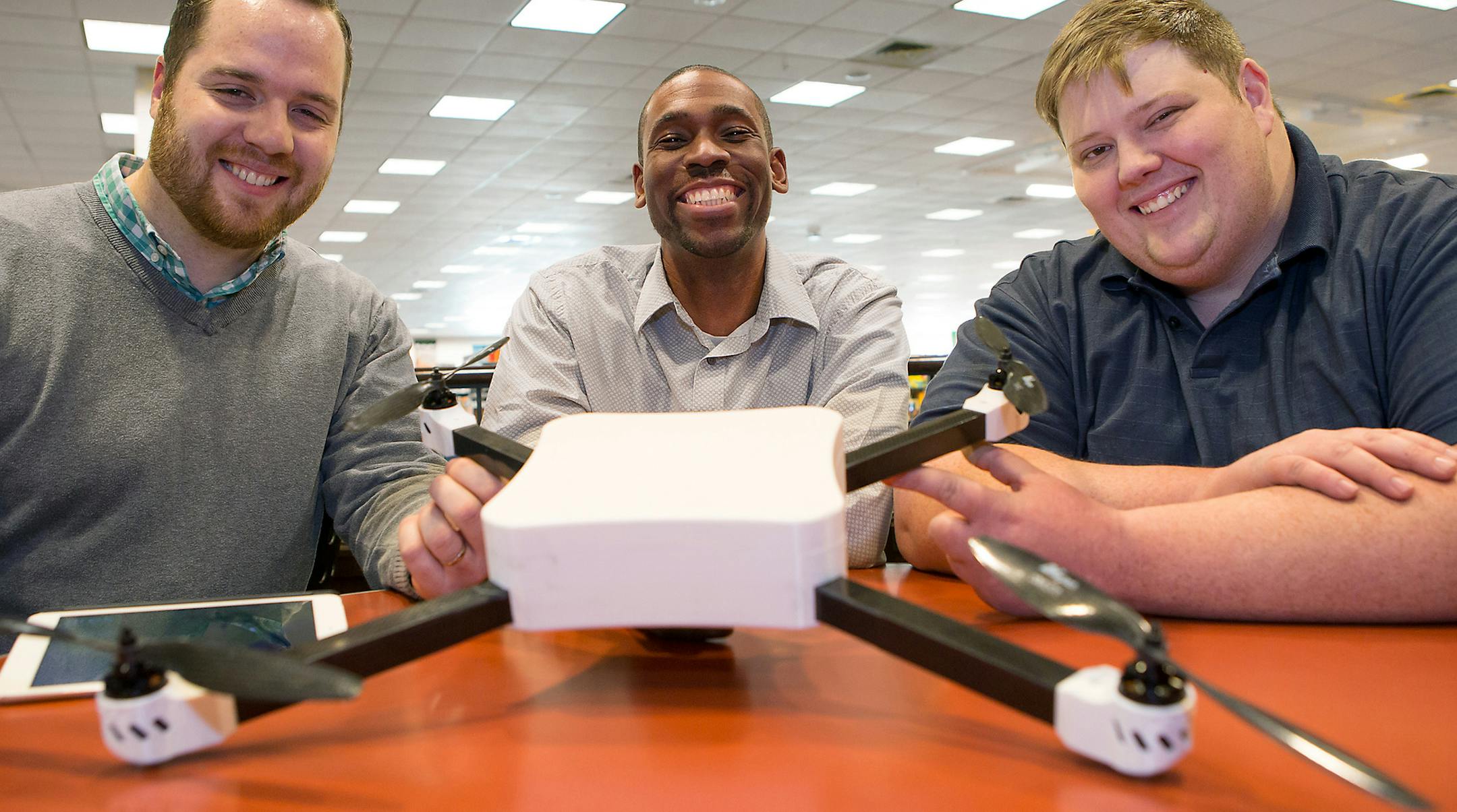 Ares Drones co founders Ben Brautigam, left, Sherwyn Saul, center, and Justin Miller pose with their quadcopter prototype Ares One on Feb. 3, 2015 in Robinson Township, Pa., after a demo flight at Settlers Cabin Park. This prototype, constructed from carbon fiber and plastic, was made with a 3D printer. Ares Drones hopes to have their system up and running by the end of this summer. (Ralph Musthaler/Pittsburgh Post-Gazette/TNS) ORG XMIT: 1163876
