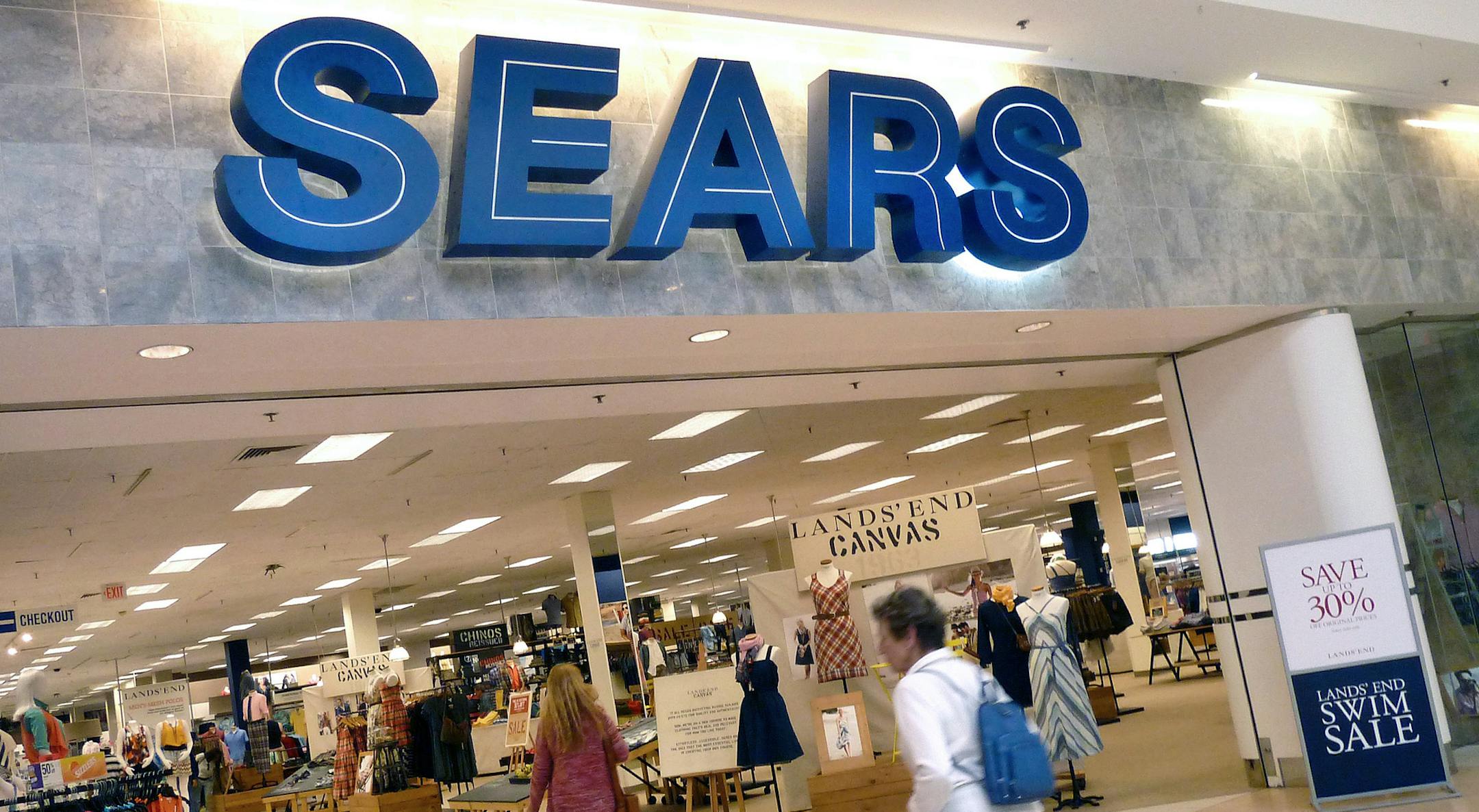 FILE - In this Thursday, May 17, 2012, file photo, shoppers walk into Sears in Peabody, Mass. Sears' announced Thursday, May 26, 2016, its fiscal first-quarter loss widened as it suffered another sales drop at its Kmart and namesake stores. The retailer also announced that it's looking at options for its prized Kenmore, Craftsman and DieHard and Sears Home Services businesses, including possible partnerships or deals that could expand distribution of its brands and service offerings. (AP Photo/E