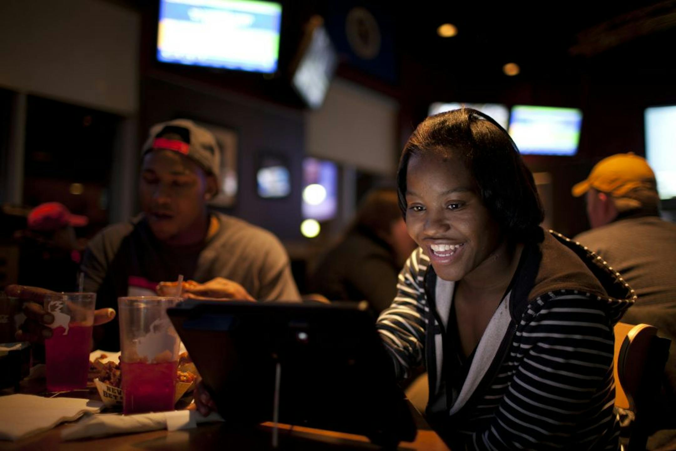 Buffalo Wild Wings is one of the first national restaurant chains to offer Apple iPads at tables so customers can order food, play games and pay their bills electronically if they wish. The concept is being test-marketed at their Oakdale, Minn. restaurant; if it goes well, a national roll-out will follow. Chnika Blair of St. Paul played with the iPad she used to order wings for herself and Jason Williams Tuesday night, March 6, 2012 at the Buffalo Wild Wings in Oakdale, Minn.