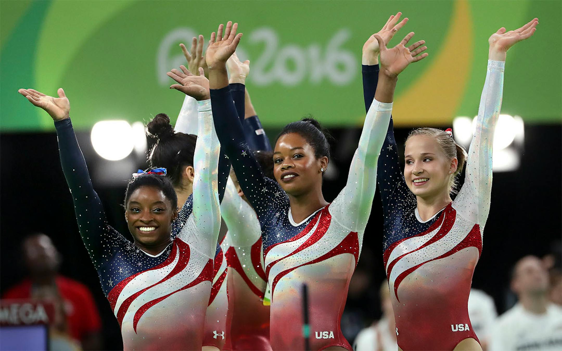 USA women's Gymnastic team took home the gold medal in team competition for the 2nd straight Olympics. (L to R) Here, Simone Biles, Gabby Douglas and Madison Kocian wave to the cheering crowd after it was announced they had won. Lauren Hernandez and Alexandra Raisman also on team on other side.