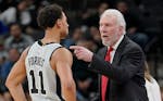 San Antonio Spurs head coach Gregg Popovich, right, talks to Spurs guard Bryn Forbes during the second half of an NBA basketball game against the Minn