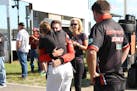 Deb Gilmore is embraced after the death of her husband, Mel Shaw, a Trans Am driver who died Sunday in a crash at Brainerd International Raceway. This
