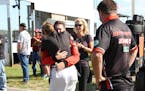 Deb Gilmore is embraced after the death of her husband, Mel Shaw, a Trans Am driver who died Sunday in a crash at Brainerd International Raceway. This