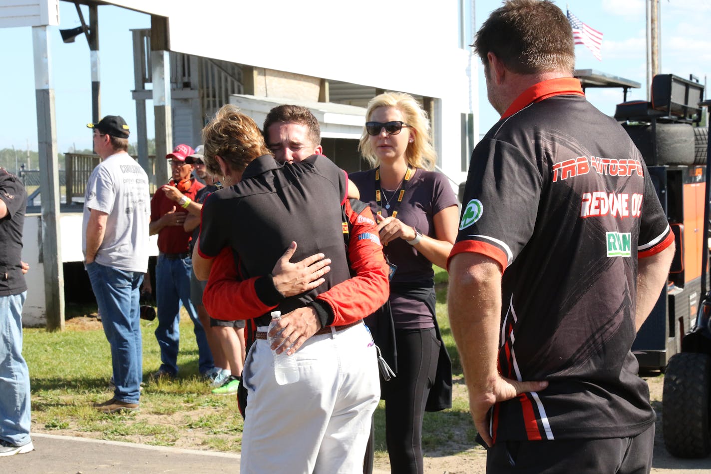 Deb Gilmore is embraced after the death of her husband, Mel Shaw, a Trans Am driver who died Sunday in a crash at Brainerd International Raceway. This is the first fatality of a racer on the track in 16 years.