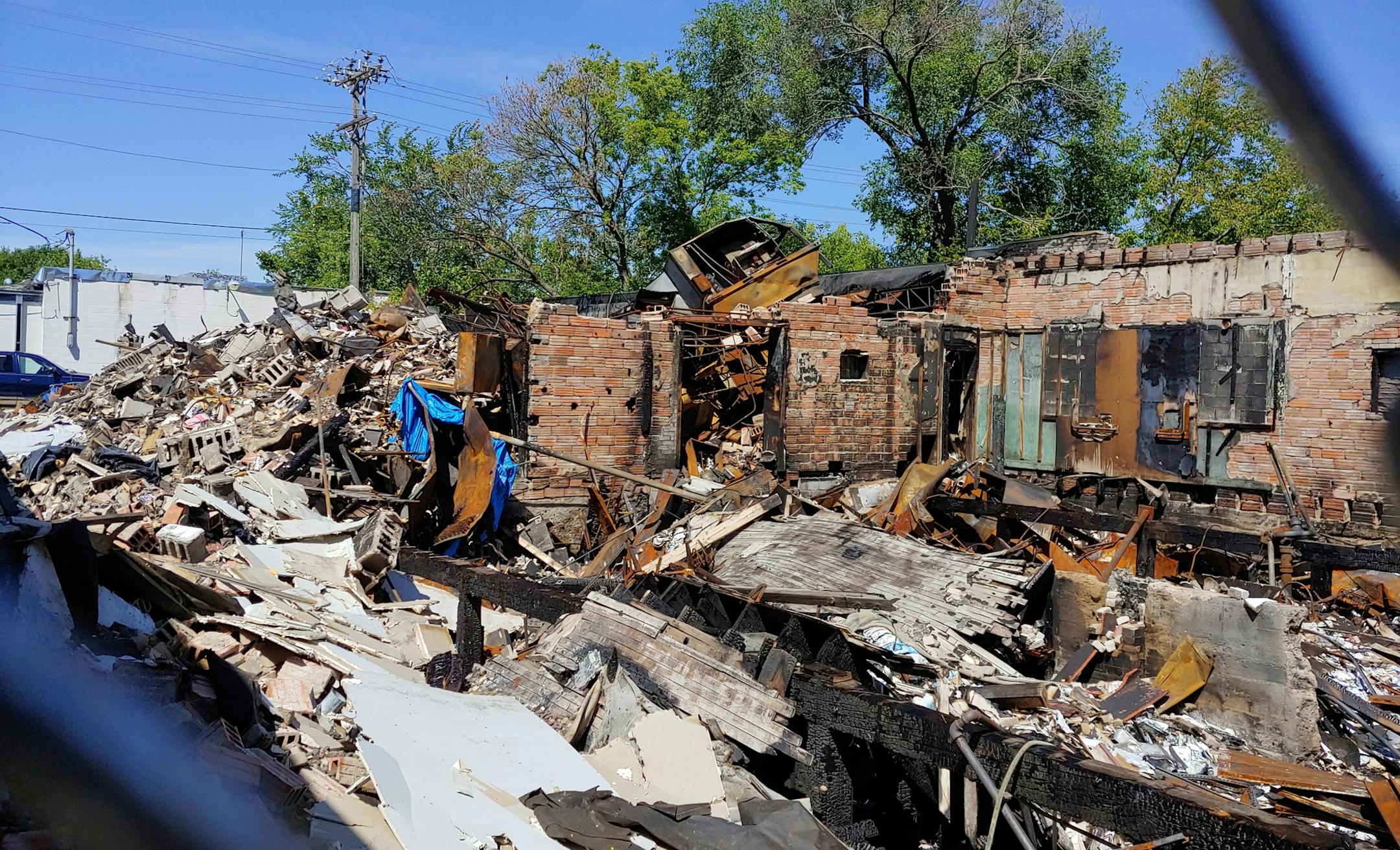 The remains of two bookstores in Minneapolis are still uncleared as of Aug. 11, more than two months after they were destroyed during May's riots. Don Blyly, owner of Uncle Hugo's and Uncle Edgar's bookstores in Minneapolis, is upset that he has to prepay $8,847 in property taxes in order to get a demolition permit. He won't know whether he can afford the cost of rebuilding until the site is cleared