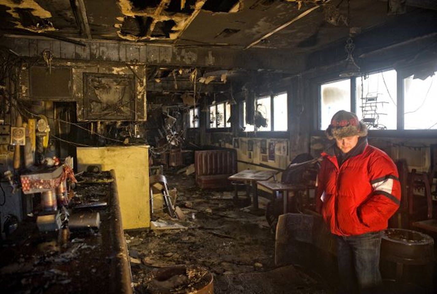 Mike Runyon, co-owner of Casper's & Runyon's Nook walked through the restaurant, heavily damaged by fire overnight.