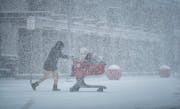 Shoppers braved the blowing snow heading to the Target parking lot, Tuesday, Feb. 22, 2022, Apple Valley, Heavy snow fell in the Twin Cities Tuesday. 